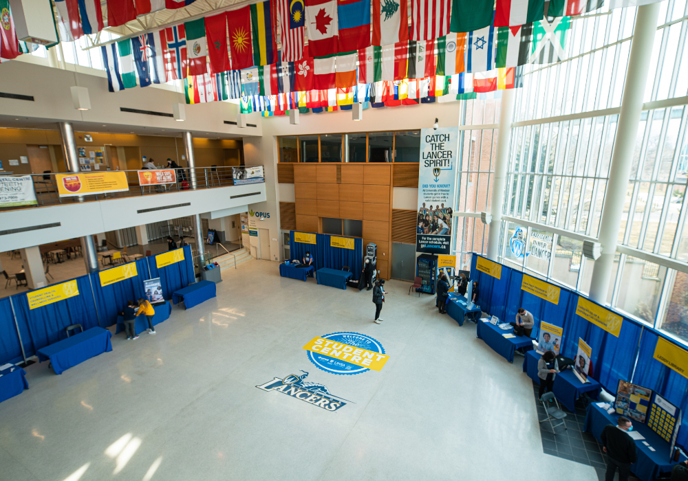 flags from various nations hanging from the ceiling of the University of Windsor's student centre lobby