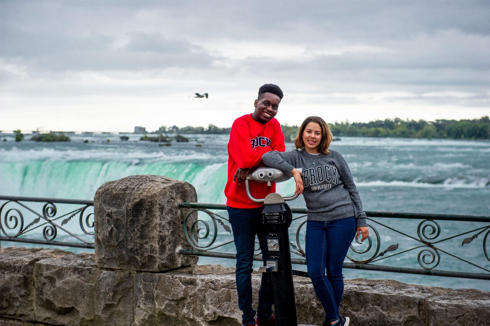 Two students posing in front of Niagara Falls