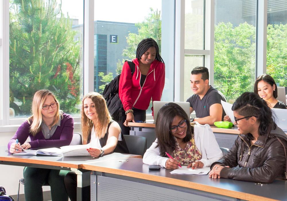 A diverse group of students in a modern classroom at Centennial College.