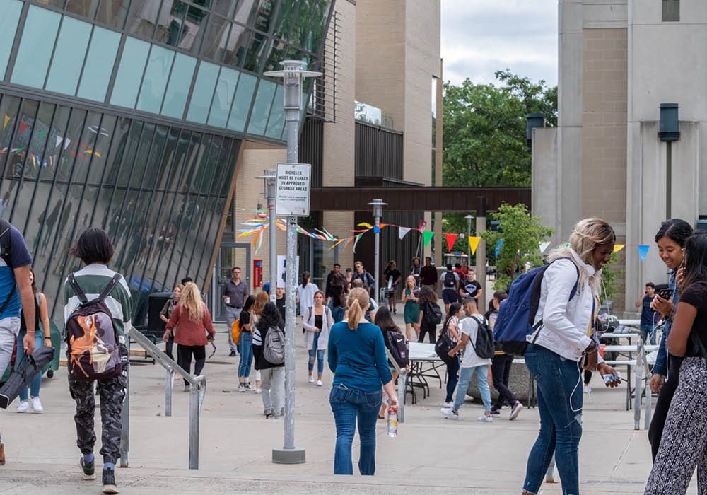 Several students travel on-foot between the McMaster University Student Centre and Mills Library at McMaster University in Hamilton, Ontario, Canada.