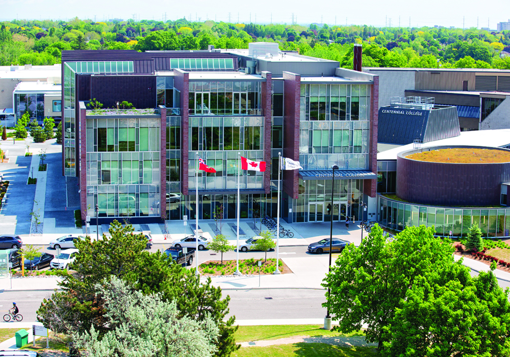 Centennial College Progress Campus. The flags for Ontario, Canada and Centennial are blowing in the wind.