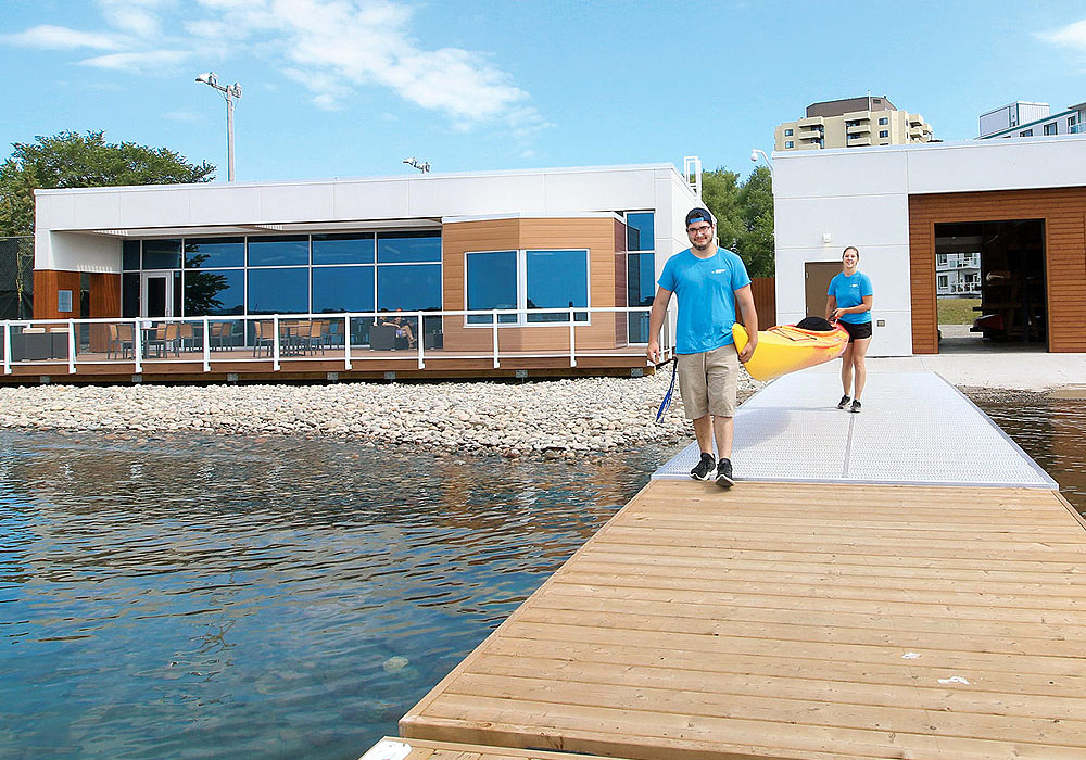 Students carrying kayak to waterfront at Sault Colleges' Waterfront Adventure Centre