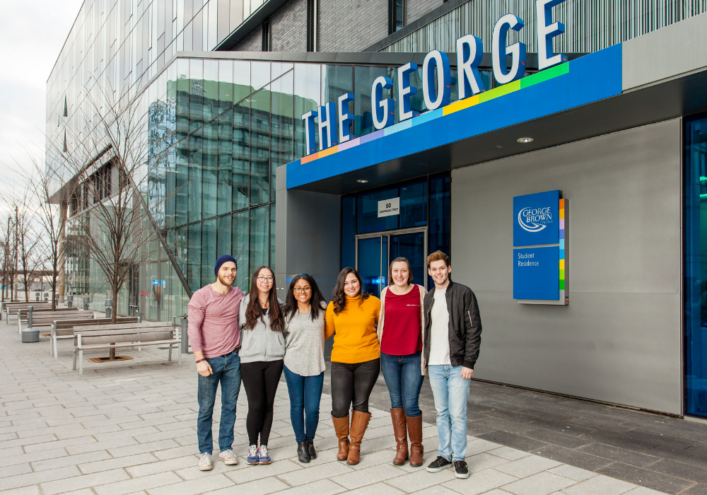 GBC students standing in front of The George, GBC's student residence.